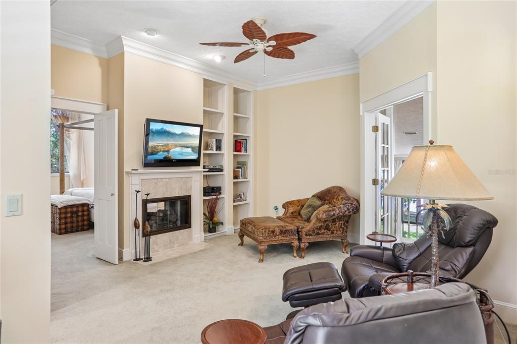 17810 Crawley Road Odessa, FL 33556 - Photo 38 of 76 a living room with furniture a flat screen tv and a fireplace