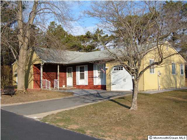 12 Stonybrook Road Whiting, NJ 08759 - Photo 1 of 25 a front view of a house with a yard and garage