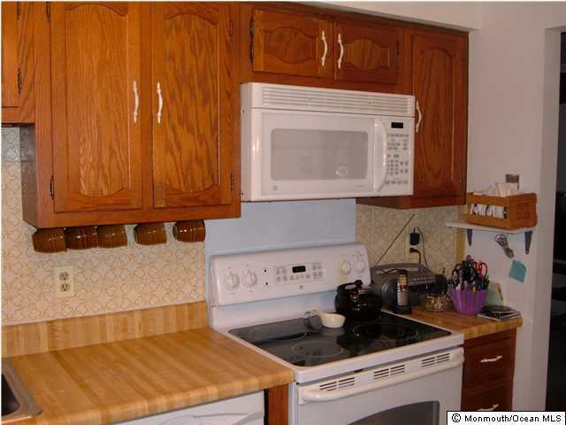 12 Stonybrook Road Whiting, NJ 08759 - Photo 14 of 25 a kitchen with a stove and cabinets