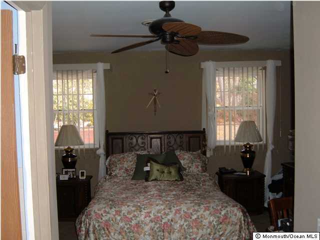 12 Stonybrook Road Whiting, NJ 08759 - Photo 21 of 25 a bed sitting in a bedroom next to a window