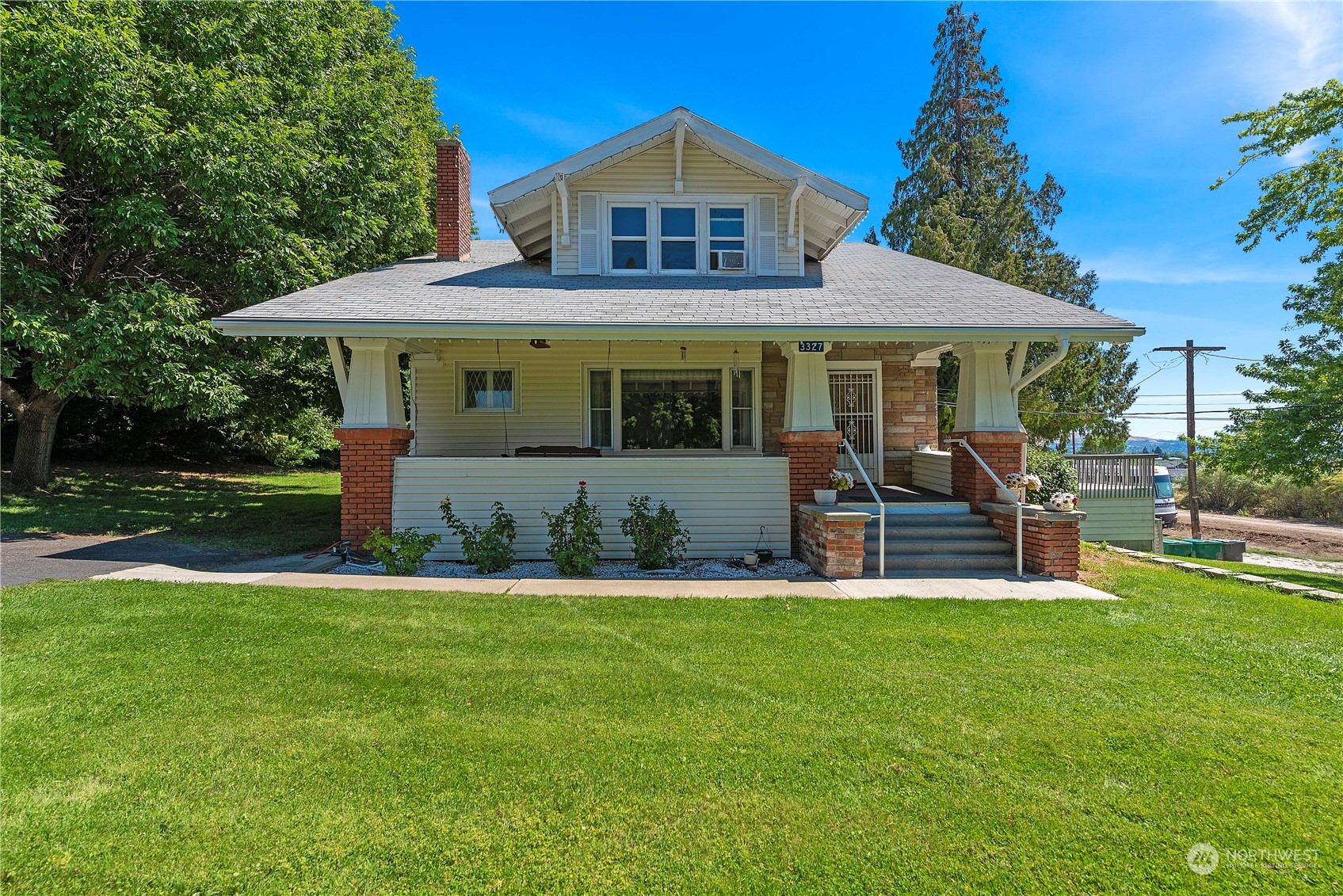 a view of a house with a yard and sitting area