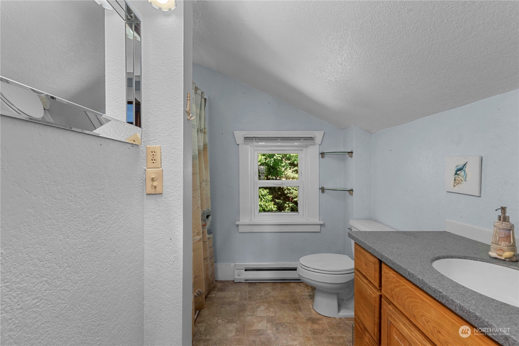 3327 Crestview Road Wenatchee, WA 98801 - Photo 13 of 39 a bathroom with a granite countertop toilet a sink and a mirror