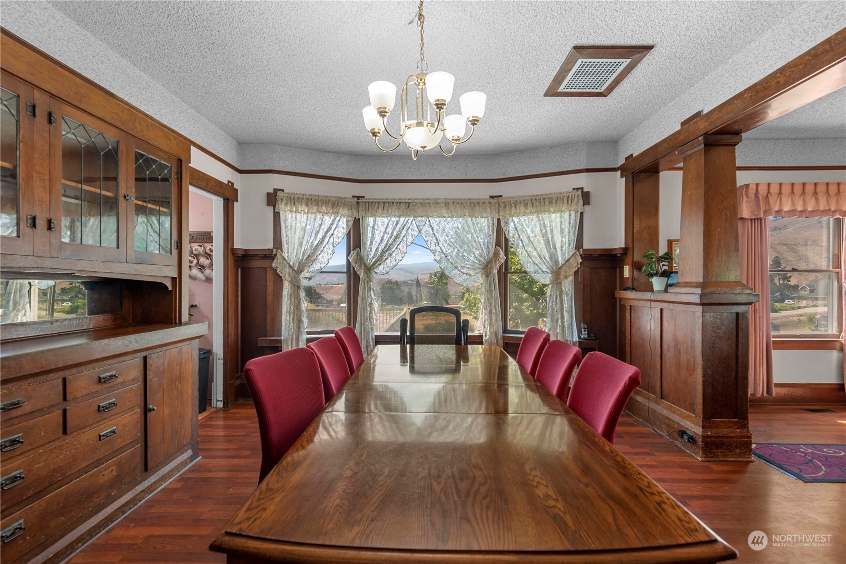 3327 Crestview Road Wenatchee, WA 98801 - Photo 10 of 39 a view of a dining room with furniture a chandelier and wooden floor