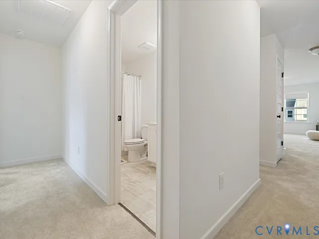 a view of a bathroom from a hallway