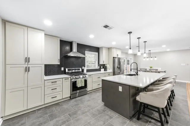 a kitchen with sink cabinets and stove top oven