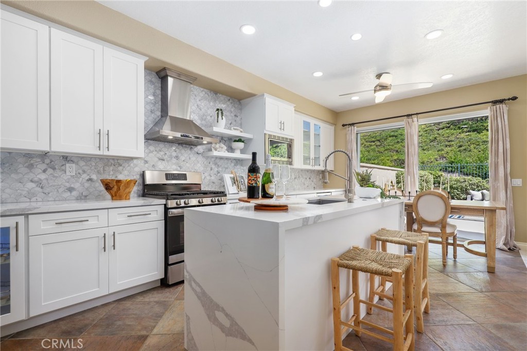 73 Blazewood Lake Forest, CA 92610 - Photo 14 of 53 a kitchen with stainless steel appliances granite countertop a stove and white cabinets