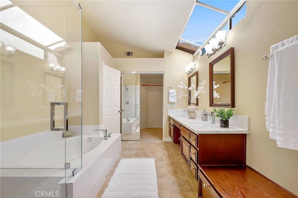 73 Blazewood Lake Forest, CA 92610 - Photo 28 of 53 a large bathroom with a double vanity sink toilet mirror and bathtub
