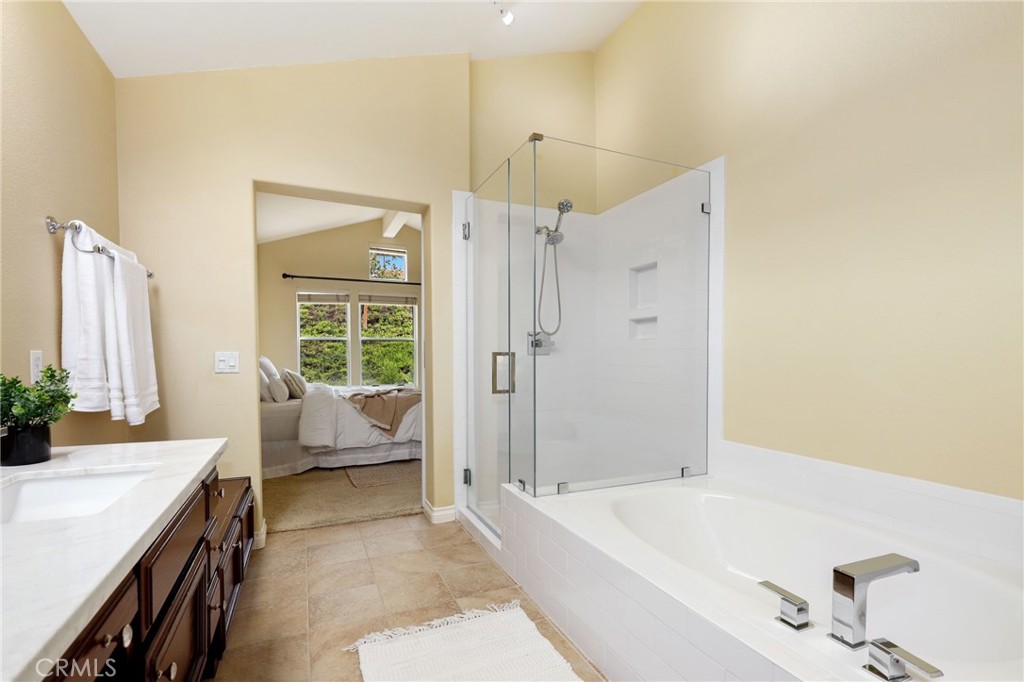 73 Blazewood Lake Forest, CA 92610 - Photo 29 of 53 a spacious bathroom with a tub sink and mirror