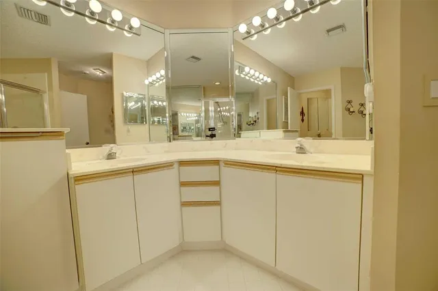 a bathroom with a sink vanity and mirror