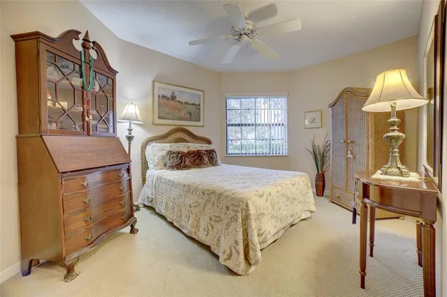 a bedroom with a bed couch and window