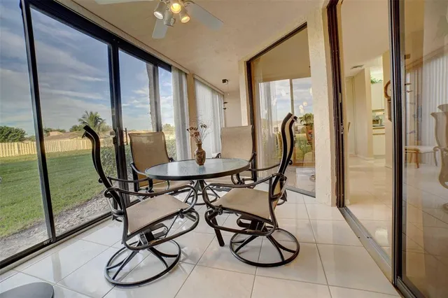 a view of swimming pool with furniture and floor to ceiling window