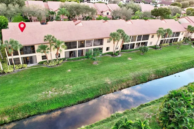 aerial view of a house with a yard