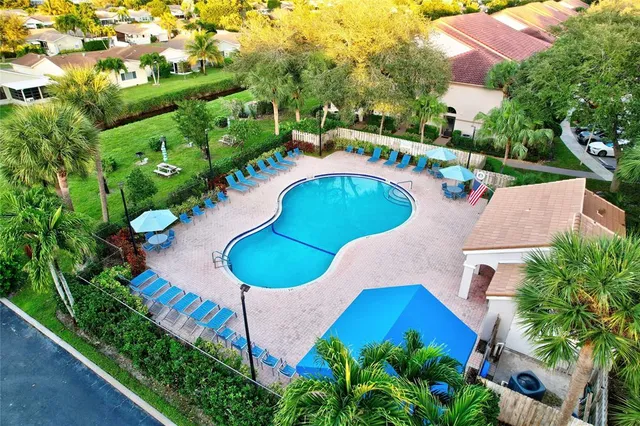 an aerial view of a house with a swimming pool yard and outdoor seating
