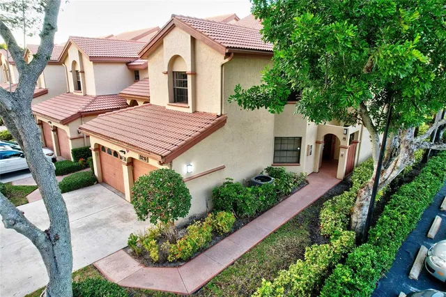 a aerial view of a house with a yard and potted plants