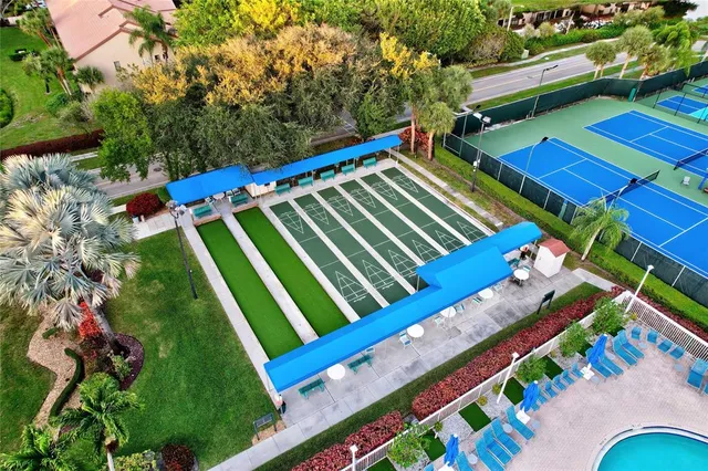 an aerial view of a house with swimming pool and outdoor seating