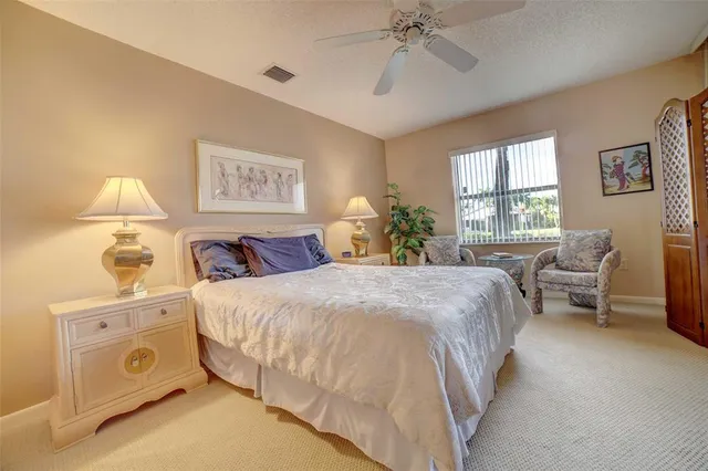 a spacious bedroom with a bed and a couch