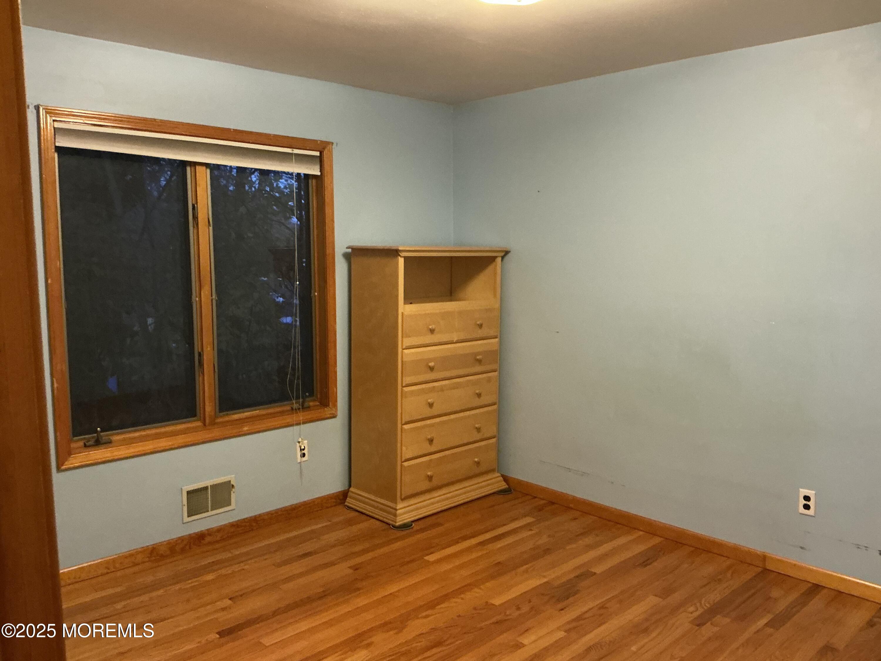 100 Solomon Street Howell, NJ 07731 - Photo 11 of 27 a view of an empty room with wooden floor and a window