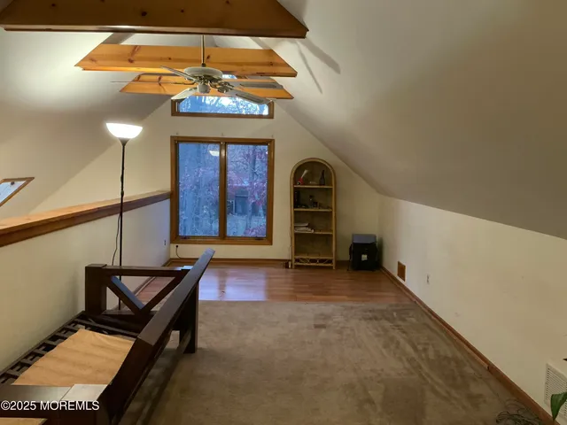 a view of a room with wooden floor and furniture