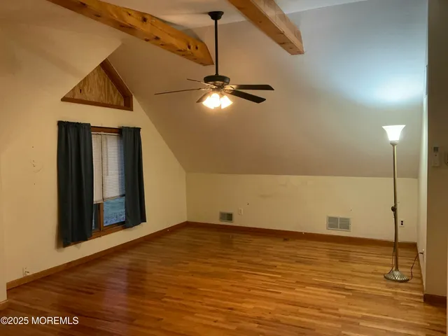 a view of hallway with wooden floor