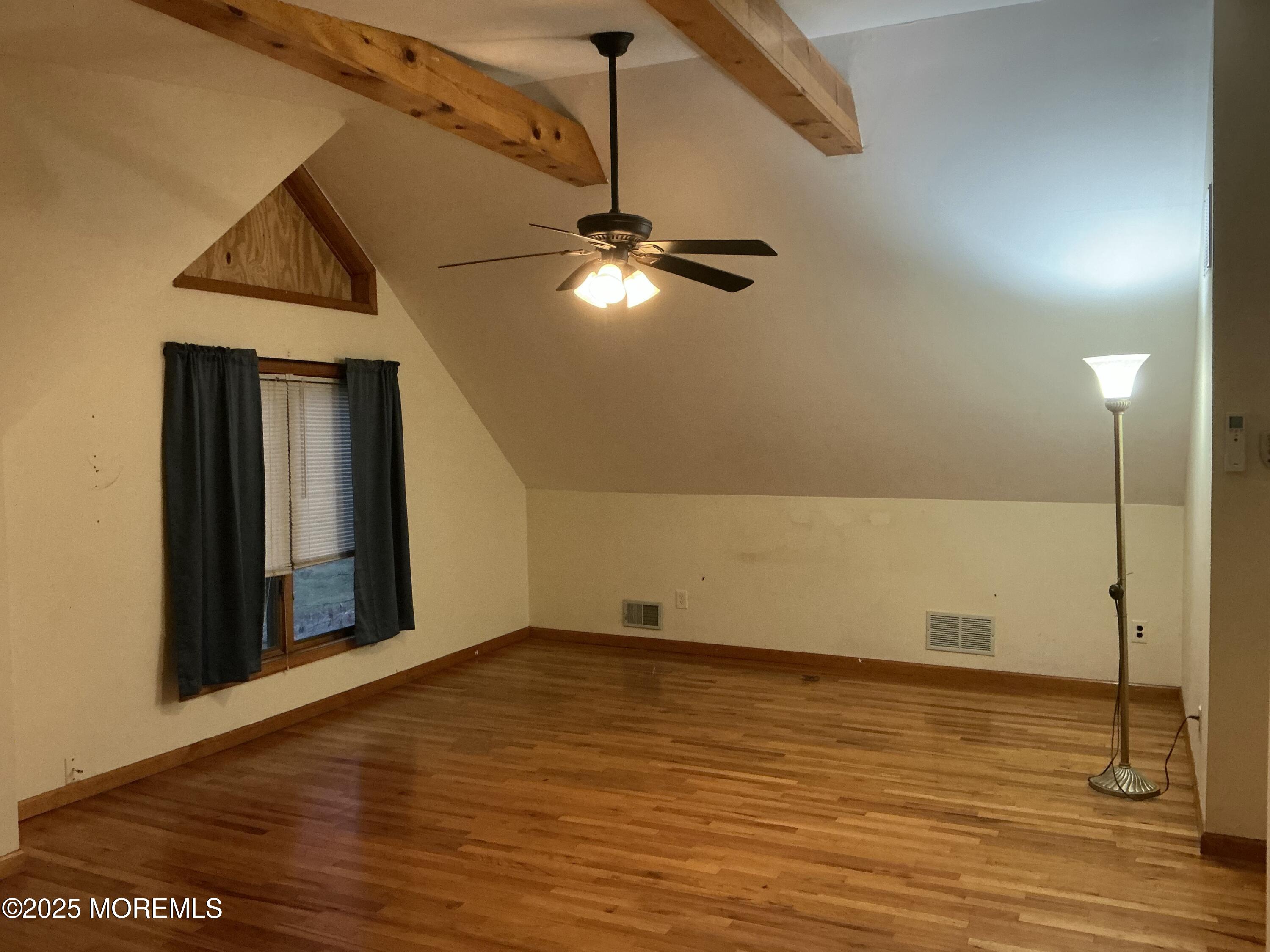 100 Solomon Street Howell, NJ 07731 - Photo 16 of 27 a view of an empty room with wooden floor and a ceiling fan