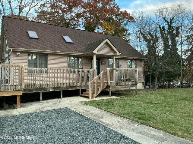 a view of a house with a yard and a porch