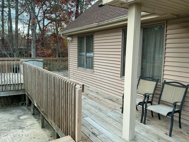 a view of house with deck and outdoor seating