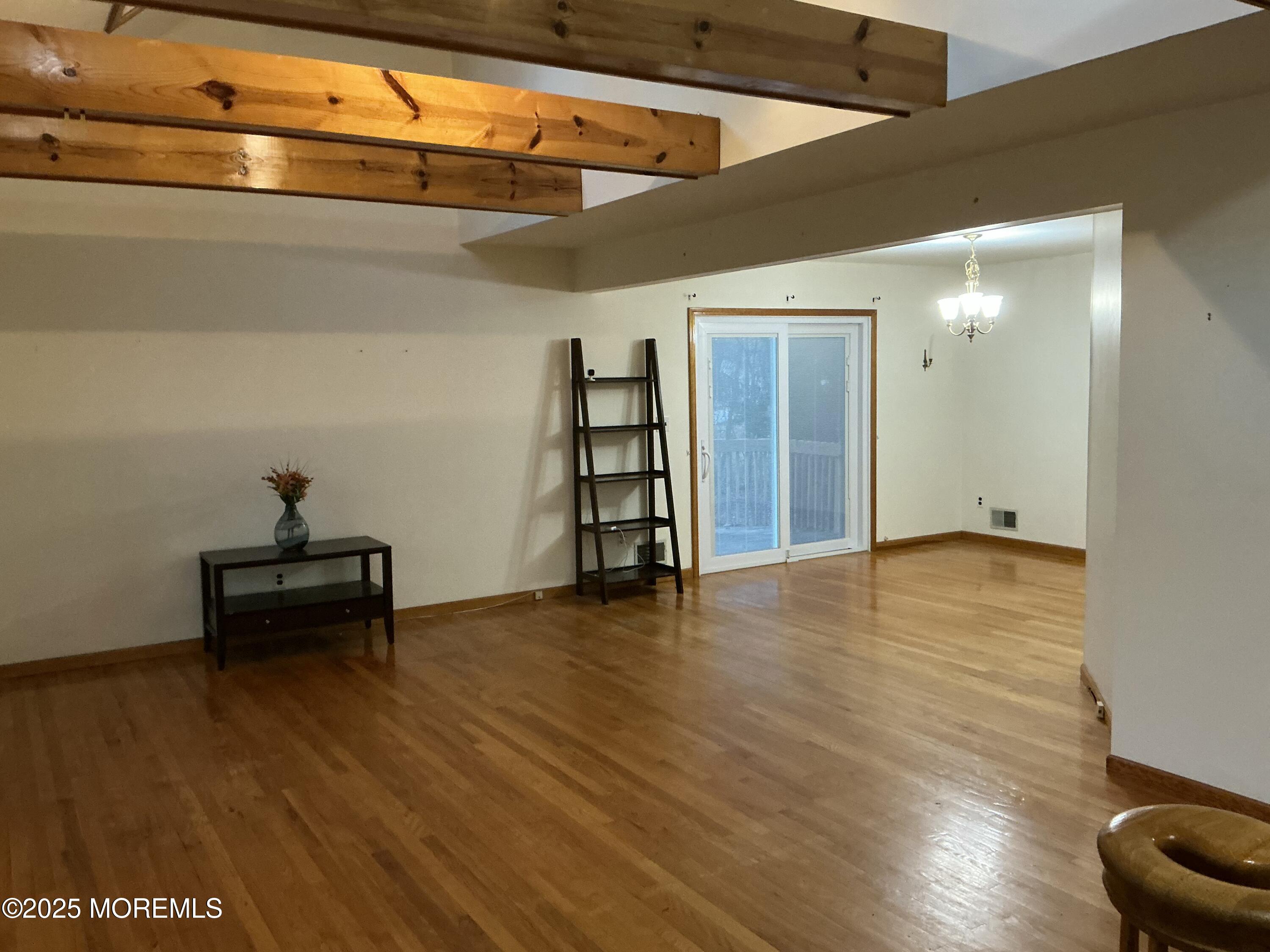 100 Solomon Street Howell, NJ 07731 - Photo 3 of 27 a view of an empty room with wooden floor and a window