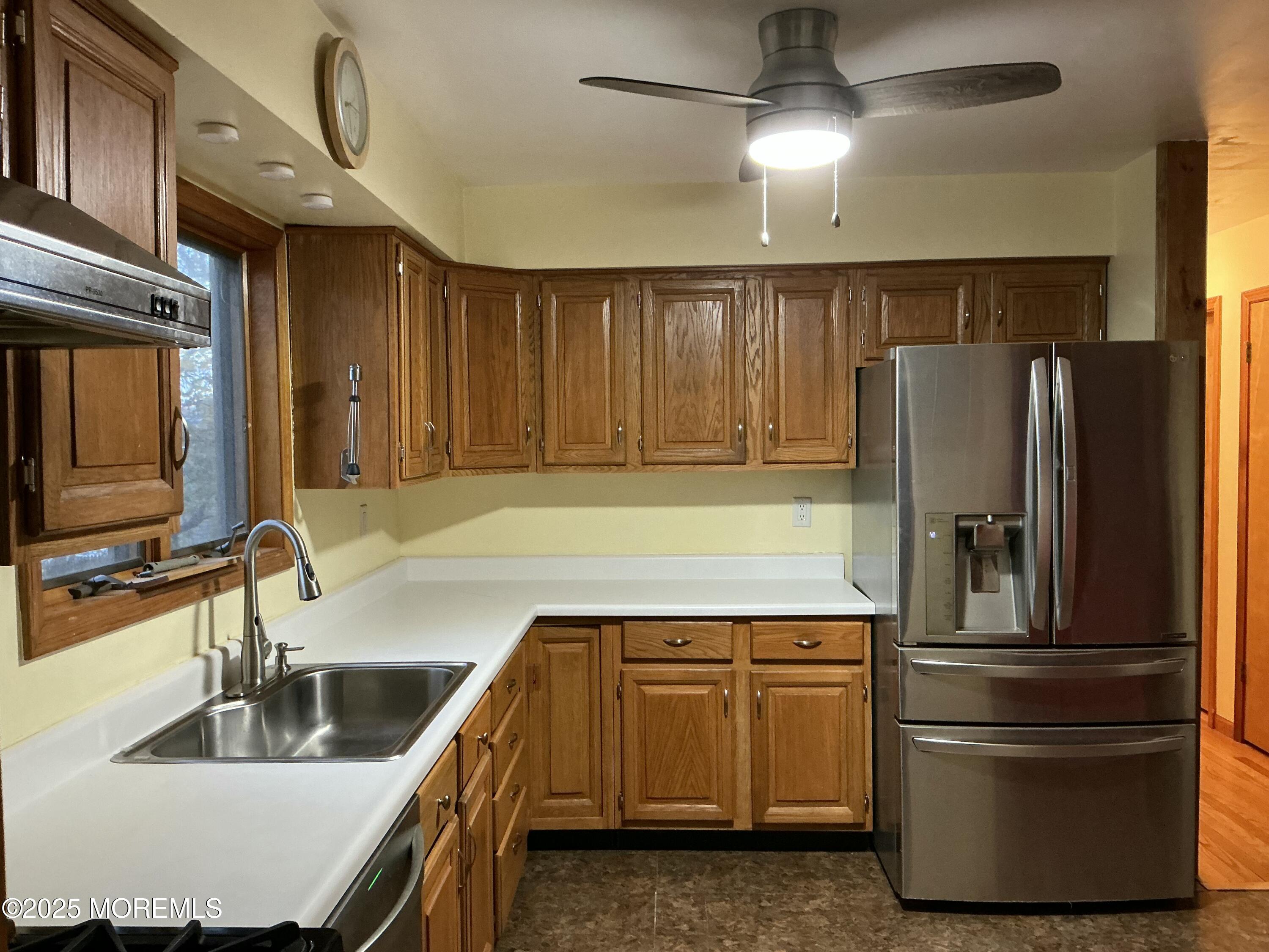 100 Solomon Street Howell, NJ 07731 - Photo 6 of 27 a kitchen with kitchen island granite countertop a refrigerator and a sink