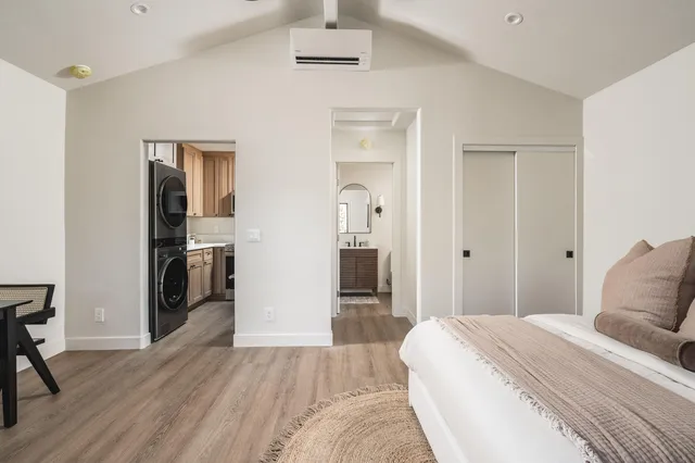 a bedroom with a bed and wooden floor