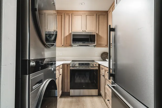 a kitchen with a stove and a refrigerator