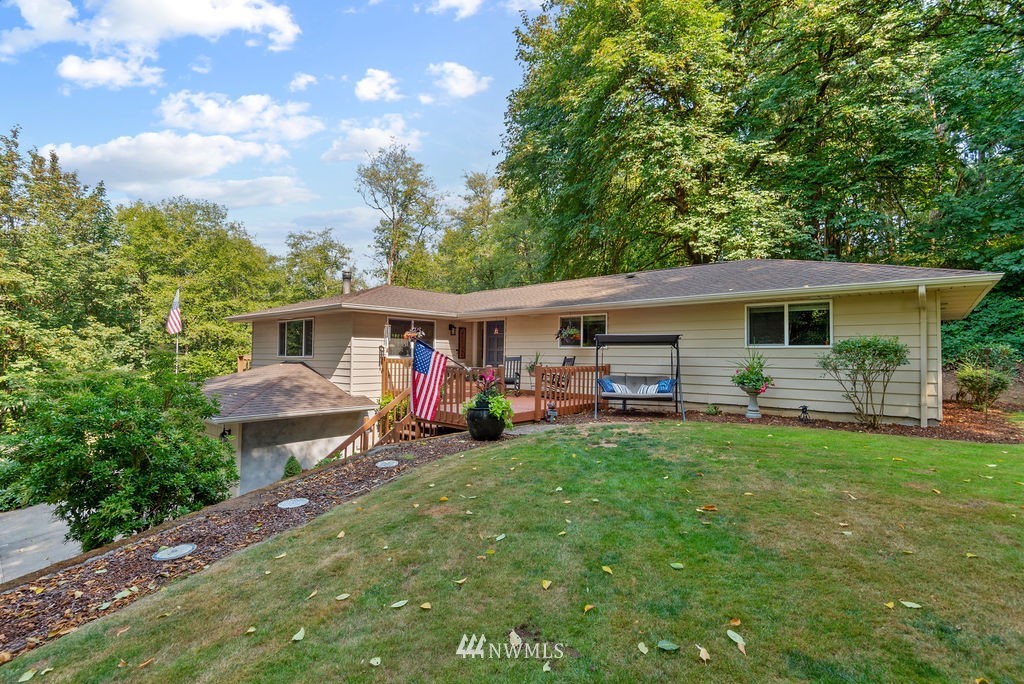 755 Hazel Dell Road Castle Rock, WA 98611 - Photo 1 of 30 a view of a house with a yard and sitting area