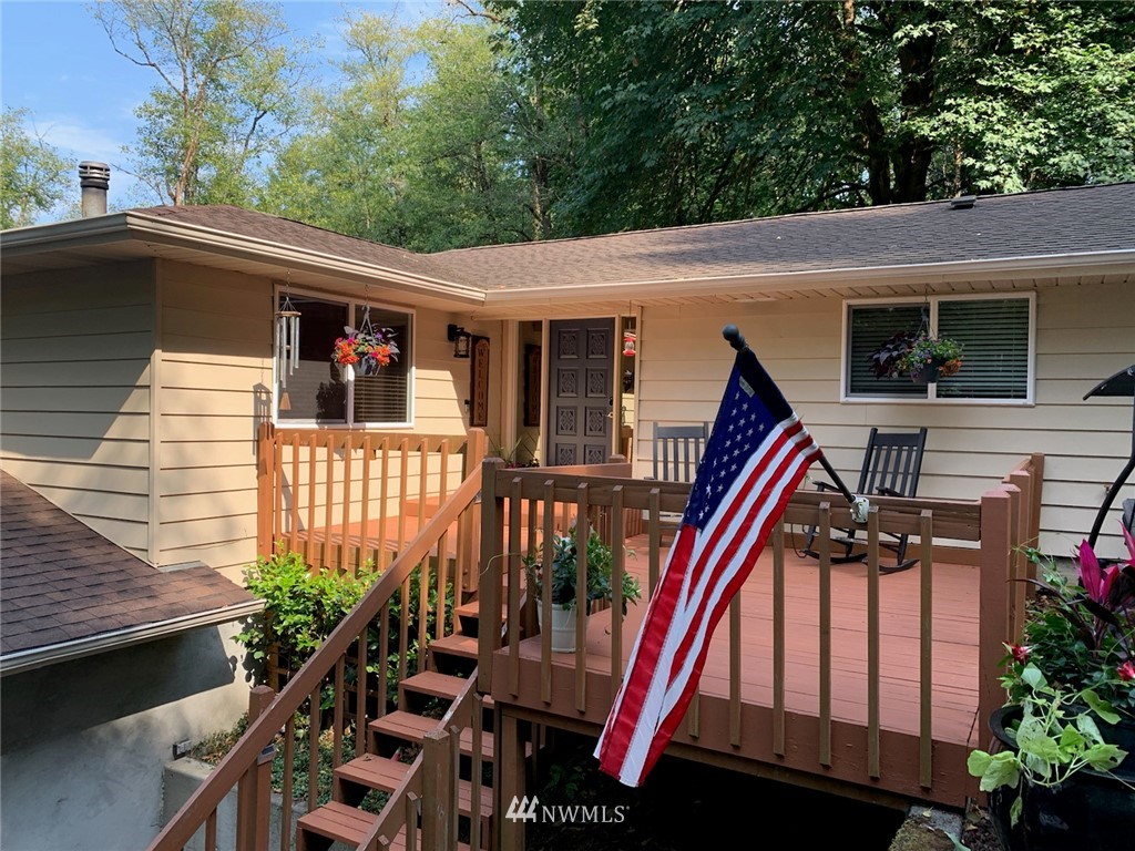755 Hazel Dell Road Castle Rock, WA 98611 - Photo 2 of 30 a front view of house with deck and outdoor seating