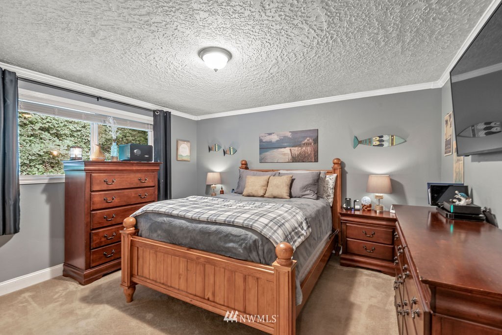 755 Hazel Dell Road Castle Rock, WA 98611 - Photo 16 of 30 a bedroom with a bed and wooden floor