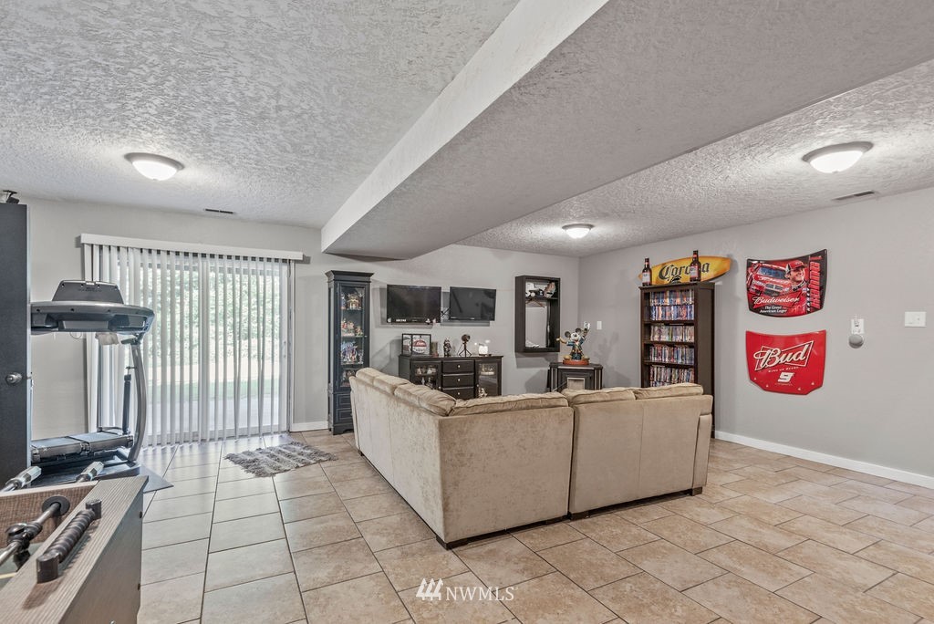 755 Hazel Dell Road Castle Rock, WA 98611 - Photo 18 of 30 a living room with furniture and a flat screen tv