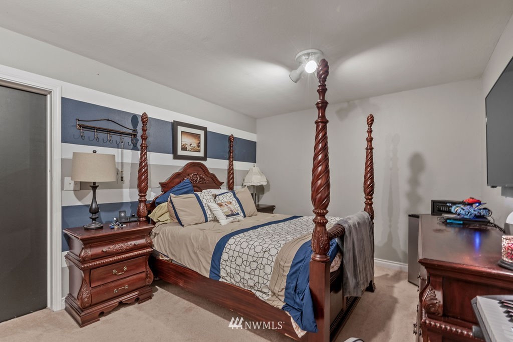 755 Hazel Dell Road Castle Rock, WA 98611 - Photo 20 of 30 a bedroom with a bed and a chandelier