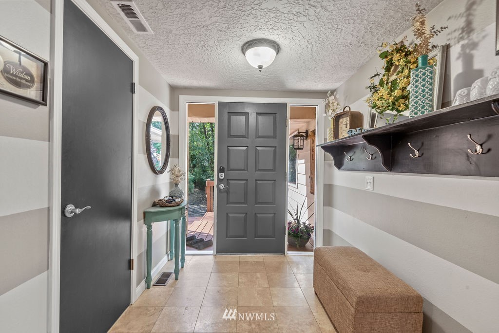 755 Hazel Dell Road Castle Rock, WA 98611 - Photo 22 of 30 a view of a hallway with entryway wooden floor and front door