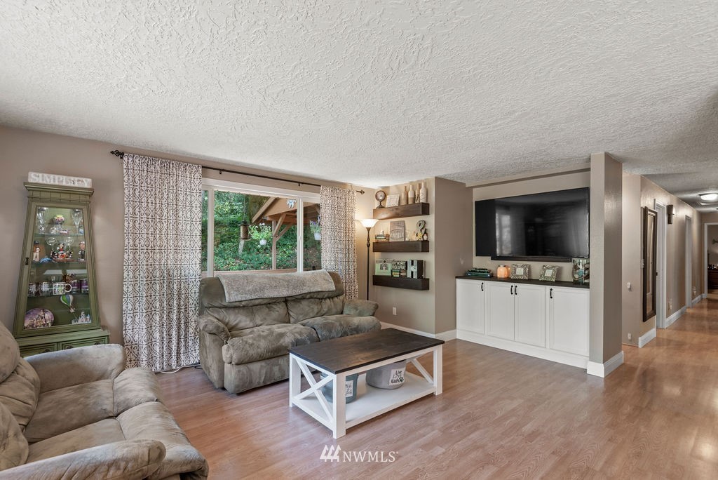 755 Hazel Dell Road Castle Rock, WA 98611 - Photo 5 of 30 a living room with furniture and a flat screen tv