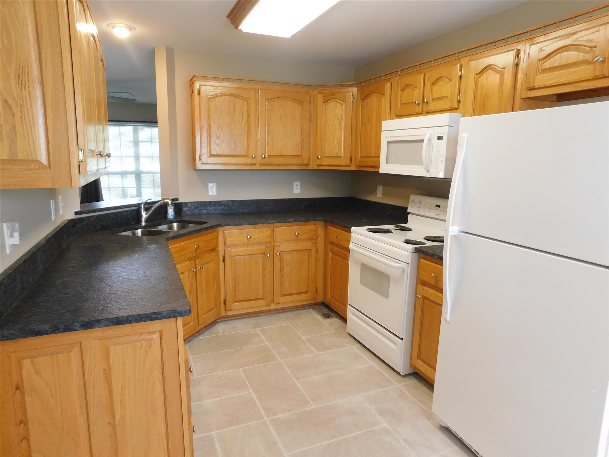 4368 Scott Hollow Road Culleoka, TN 38451 - Photo 9 of 14 Kitchen has an abundance of cabinetry and all appliances including range, microwave, dishwasher and refrigerator. New tile floor and paint.