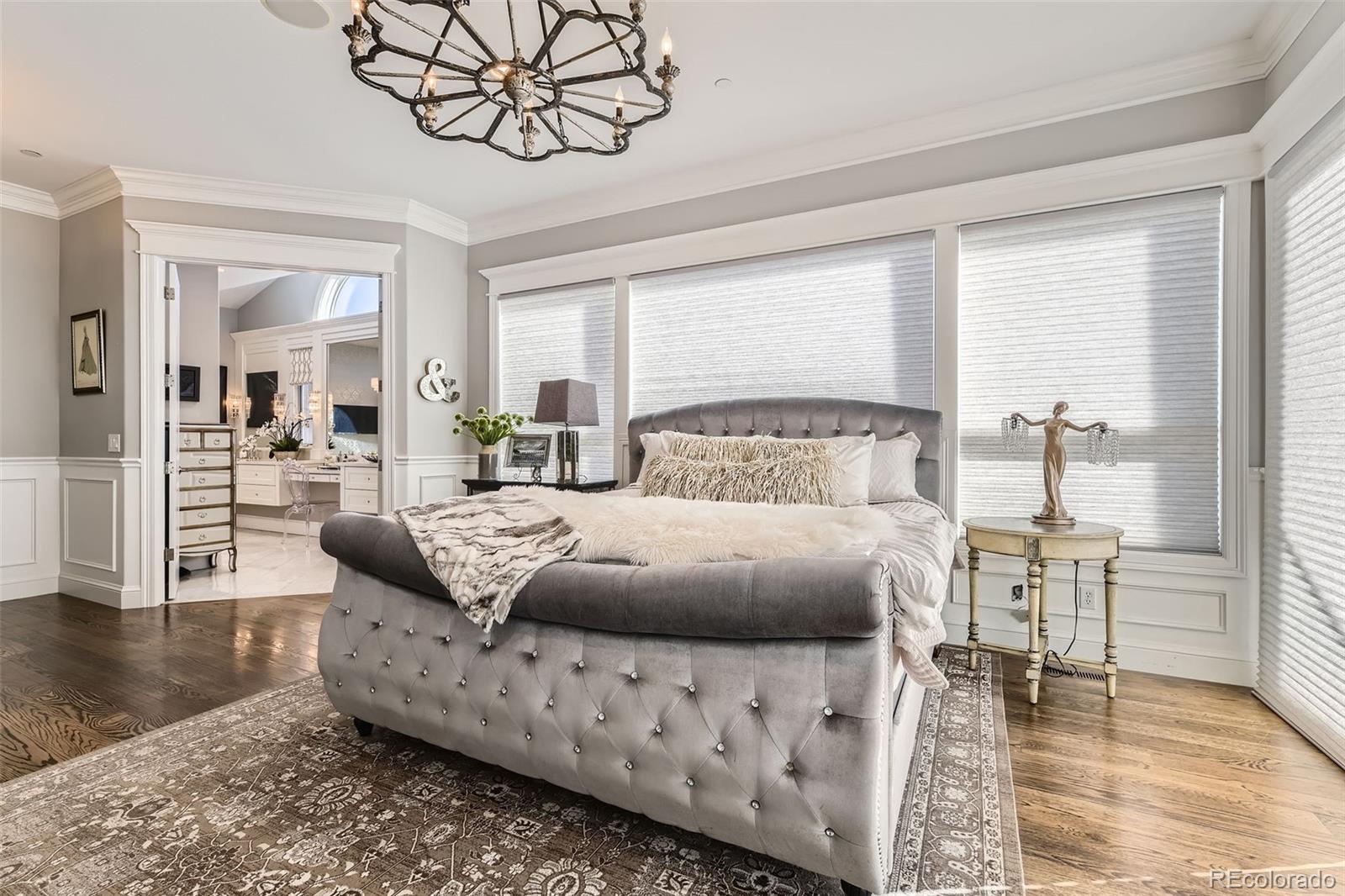 1050 Buffalo Ridge Road Castle Pines, CO 80108 - Photo 17 of 50 a bedroom with furniture and wooden floor
