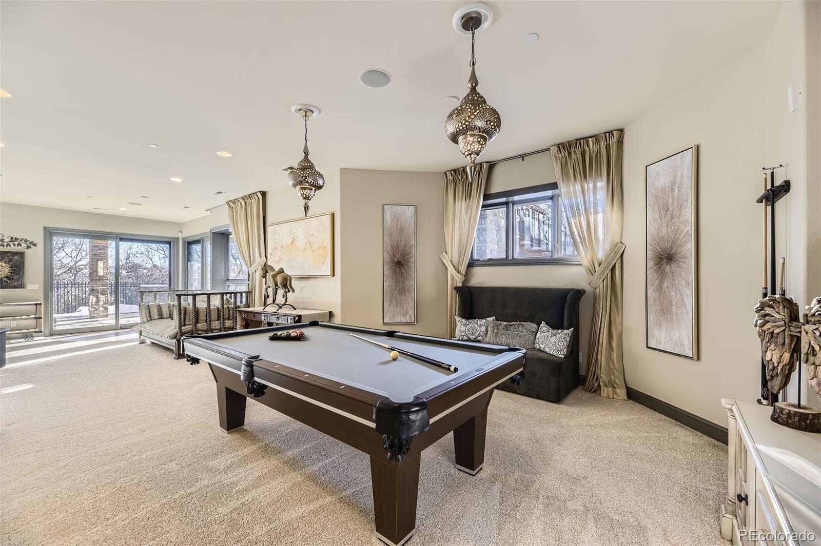 1050 Buffalo Ridge Road Castle Pines, CO 80108 - Photo 42 of 50 a room with pool table and windows
