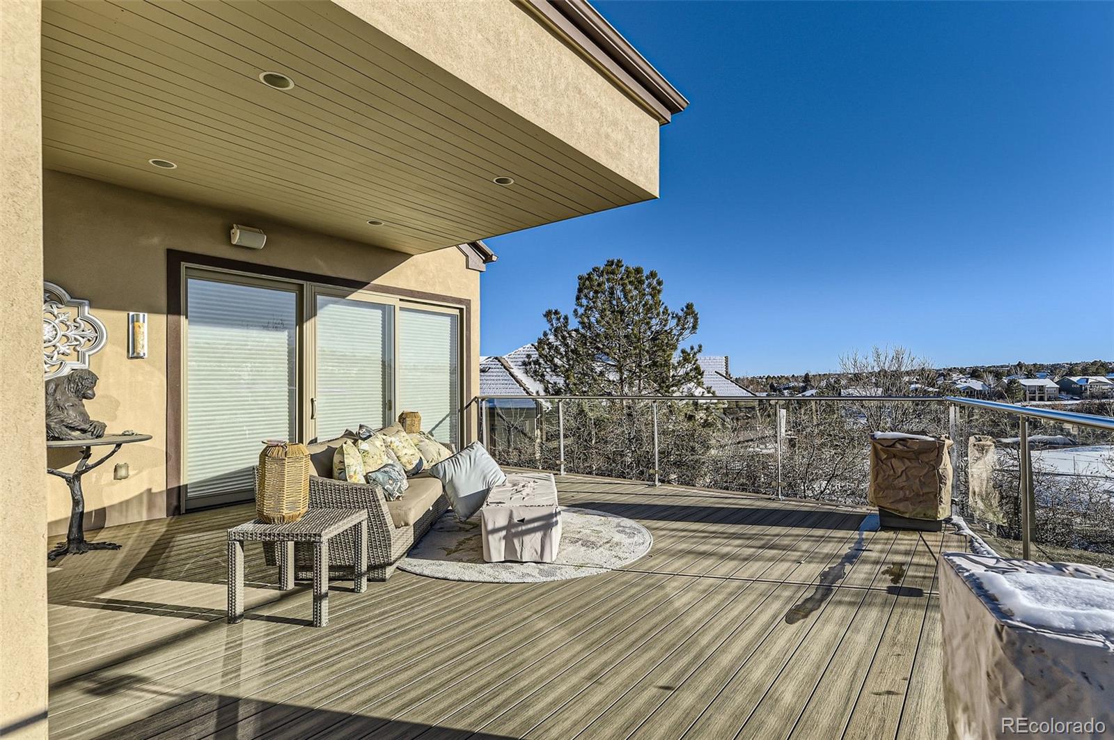 1050 Buffalo Ridge Road Castle Pines, CO 80108 - Photo 48 of 50 a view of a balcony with chairs and wooden floor