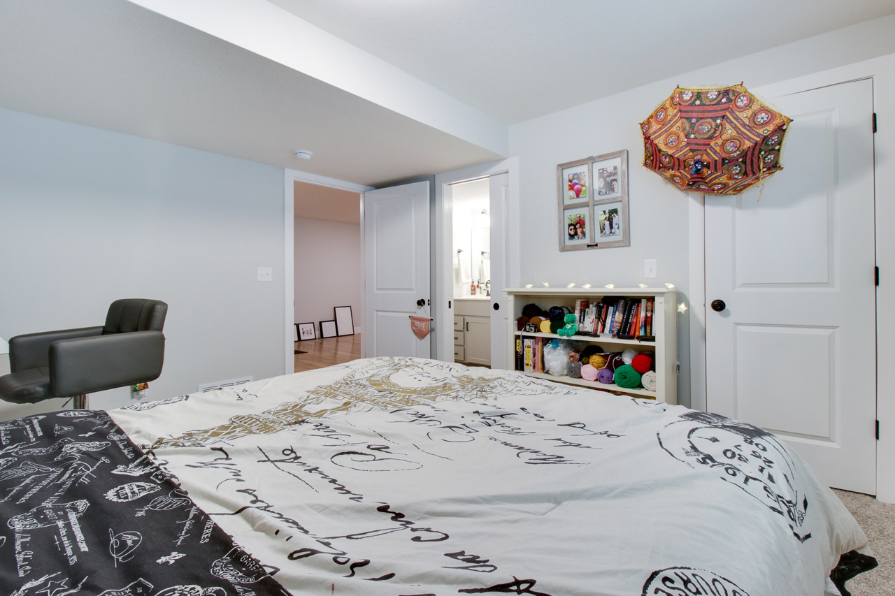 1903 Glenbridge Road Bloomington, IL 61704 - Photo 23 of 33 a bedroom with a bed and a chandelier