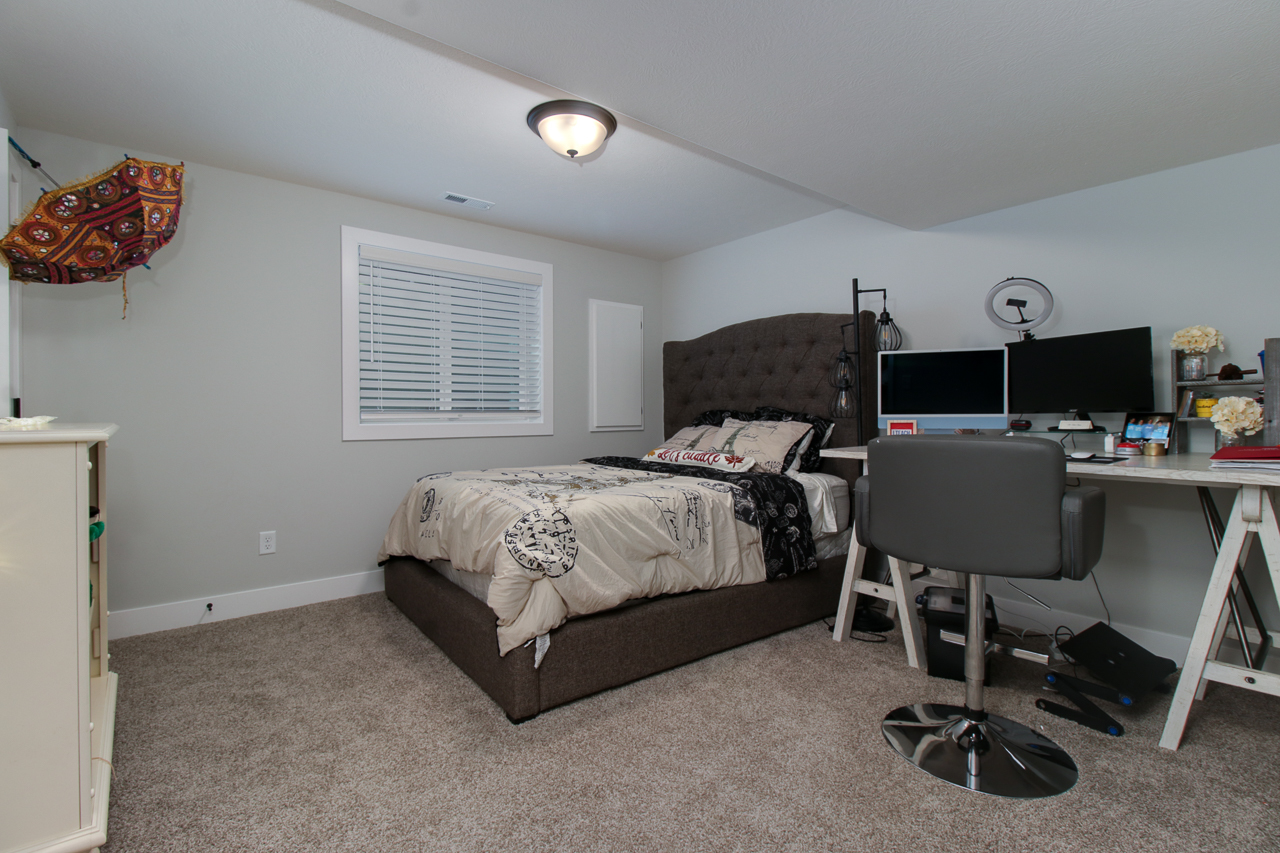 1903 Glenbridge Road Bloomington, IL 61704 - Photo 24 of 33 a bedroom with a bed a desk and chair