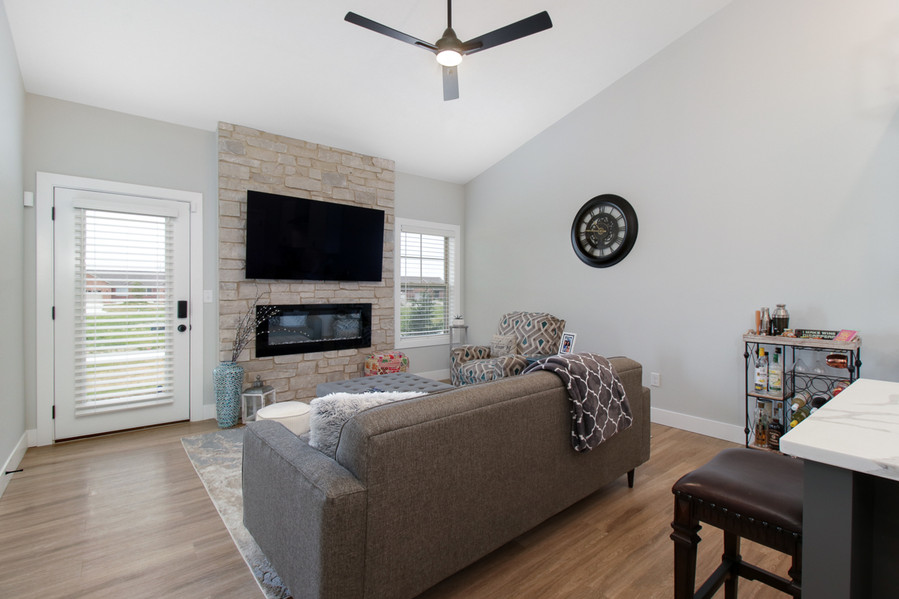 1903 Glenbridge Road Bloomington, IL 61704 - Photo 7 of 33 a living room with furniture a flat screen tv and a fireplace