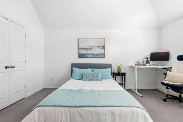 a bedroom with a bed and a chair