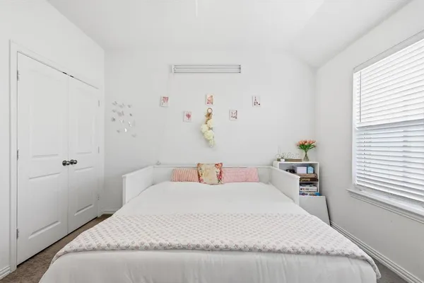 a bedroom with a white bed and a table