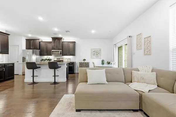 a living room with furniture and kitchen view