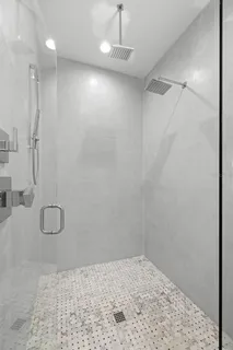a white toilet and tub sitting next to a bathroom sink