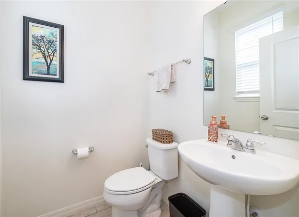 a bathroom with a sink toilet and a mirror