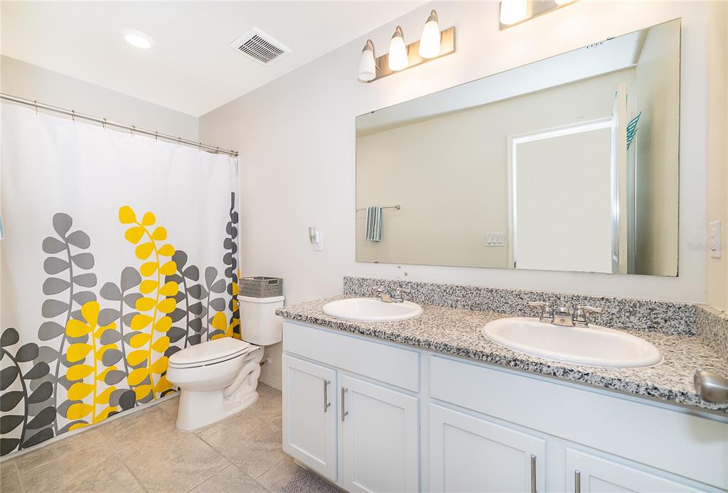 5849 Soter Lane Windermere, FL 34786 - Photo 15 of 31 a bathroom with a granite countertop sink and a mirror